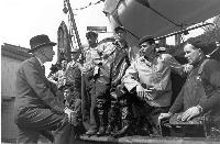Governor General Vincent Massey speaks with a group of fishermen (St. John’s, Newfoundland). Date: August 1955. Photographer: Gar Lunney, National Film Board of Canada. Reference: National Archives of Canada, PA-211709.